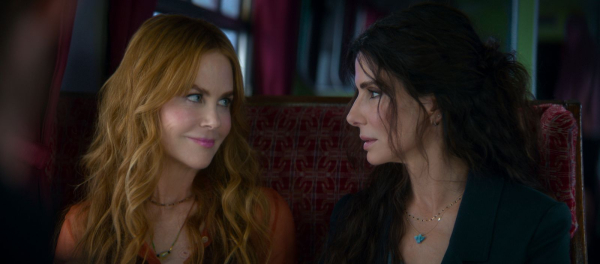 Nicole Kidman and Sandra Bullock look at each other in a still from the Practical Magic 2 film.